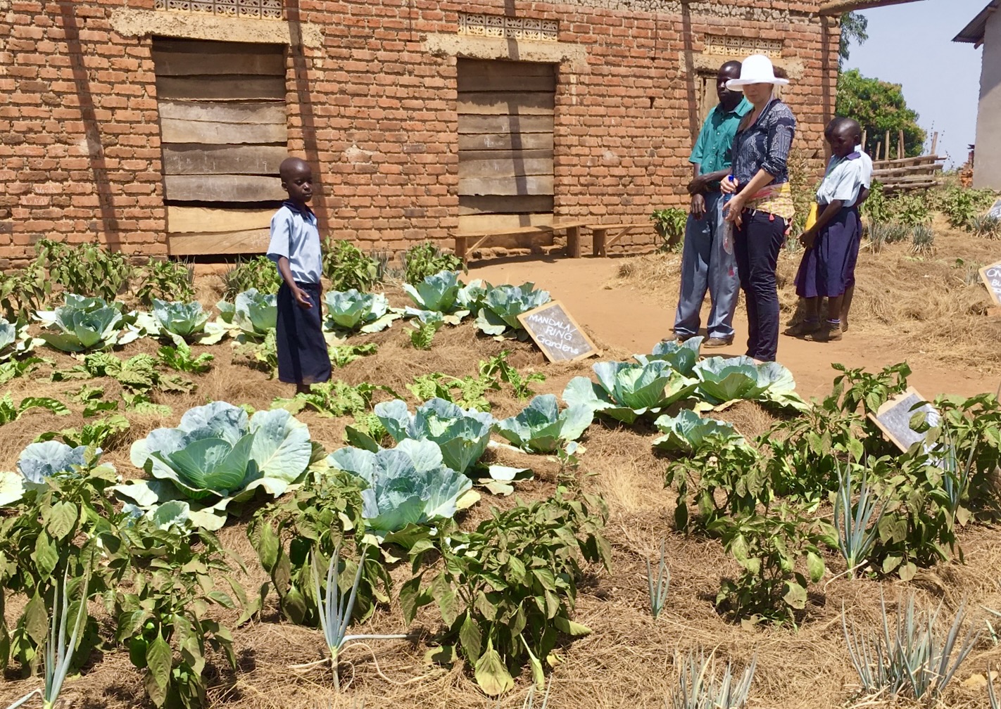 Founder Ragna and project partner inspecting some of the plants in the school gardens